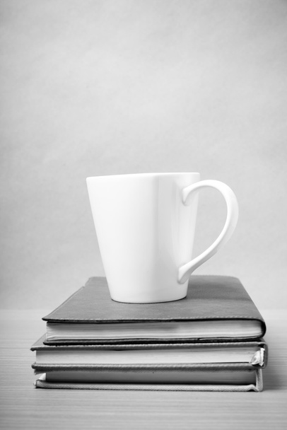 stack of book with coffee mug black and white tone style - Фото, изображение