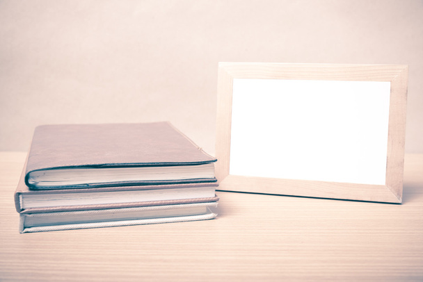 stack of book and photo frame vintage style - 写真・画像