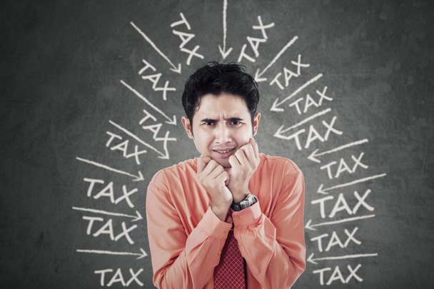 Worried businessman with tax pressure - Foto, immagini