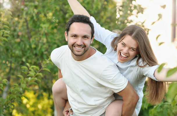 young couple having fun in the garden by their house - Photo, Image