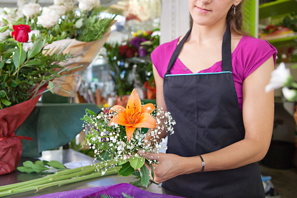 florist woman works in her store - Fotó, kép