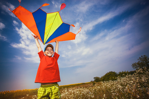 Kid flies a kite into the blue sky - Foto, immagini