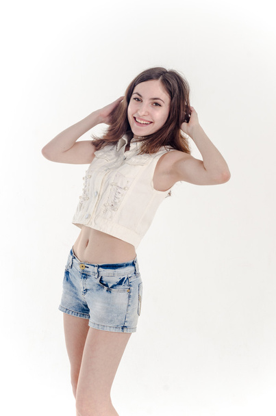 Cheerful young teen girl in denim shorts - Фото, изображение
