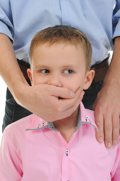 Man closes a mouth a hand to the boy - 写真・画像