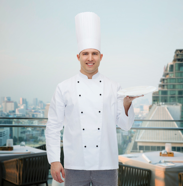 щасливий кухар чоловіків, що показує порожню тарілку
 - Фото, зображення
