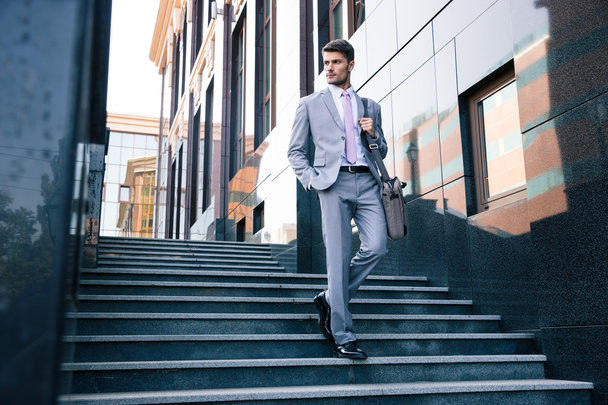 Businessman walking on stairs outdoors - Fotoğraf, Görsel