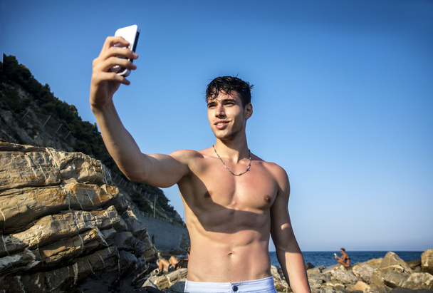 Shirtless Young Man Taking Selfie Photos at the Beach - Foto, immagini