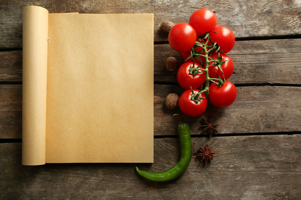Open recipe book, vegetables and spices - Fotó, kép