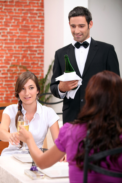 Women drinking champagne in a restaurant - Foto, Imagem