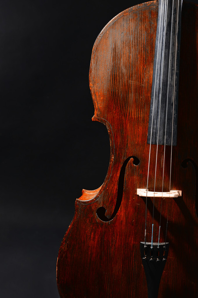 Vintage cello on dark background - Foto, afbeelding