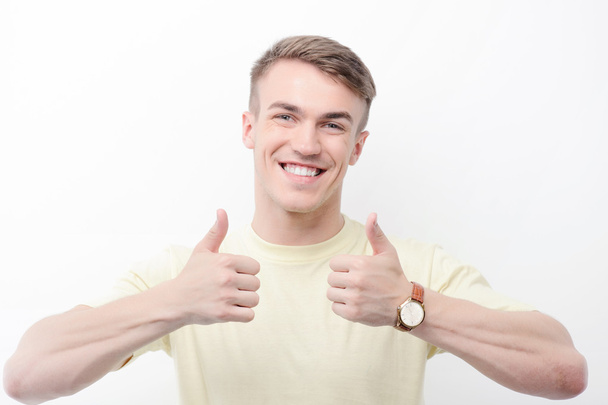 Smiling man thumbing up on isolated background  - Foto, imagen