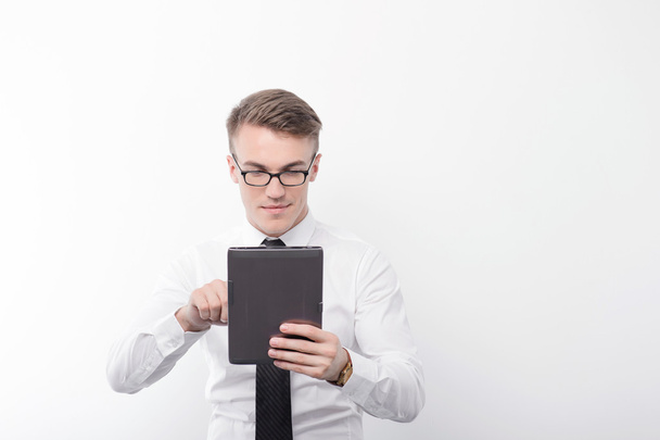 Businessman holding tablet on isolated background  - Foto, afbeelding