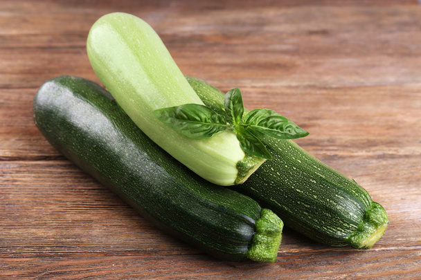 Fresh zucchini with squash and basil on wooden background - Foto, Imagen