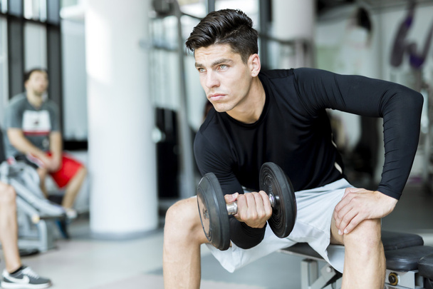 Young man training in a gym - Photo, Image