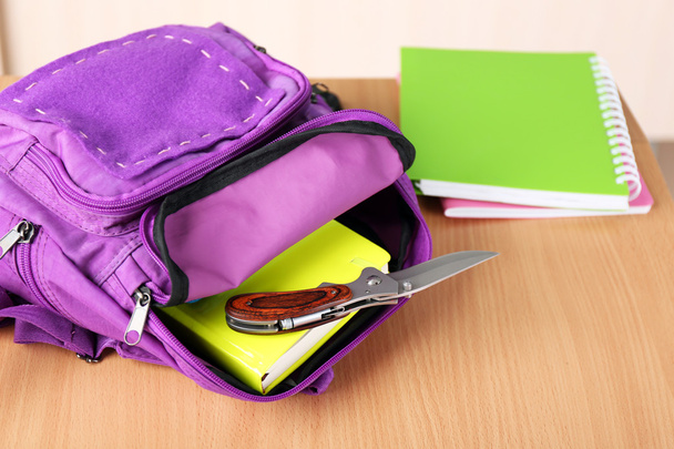 Backpack with knife in classroom, close up. Juvenile delinquency - 写真・画像