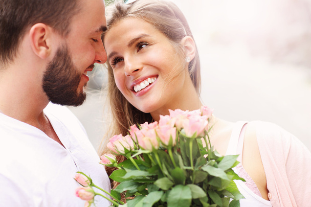 Young romantic couple with flowers - Foto, imagen