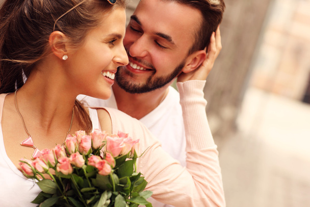 Young romantic couple with flowers - Photo, Image