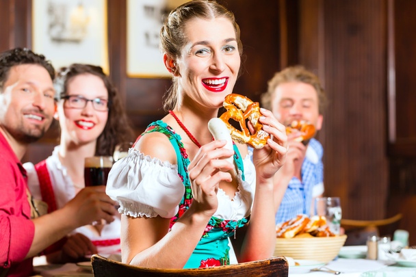 People in Bavarian Tracht eating in restaurant or pub - Foto, Bild