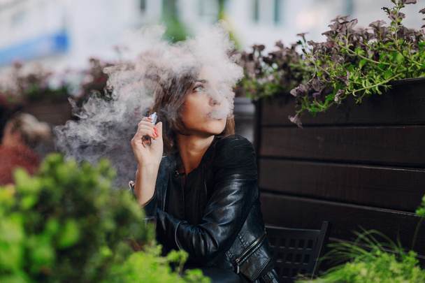 beautiful glamorous brunette smoke electronic cigarette - Photo, Image
