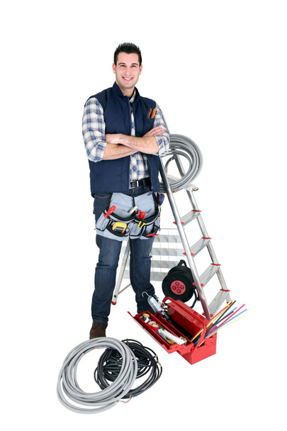 Confident electrician standing on white background - Zdjęcie, obraz
