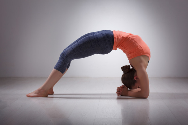 Beautiful sporty fit yogi girl practices yoga asana viparita dan - 写真・画像