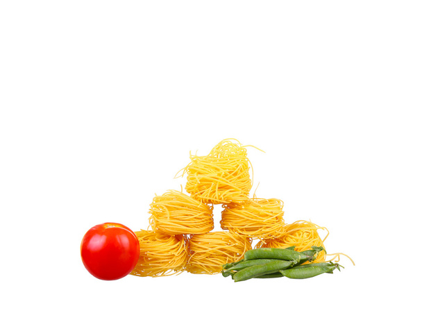 row dry nest pasta on white and cherry - Fotó, kép