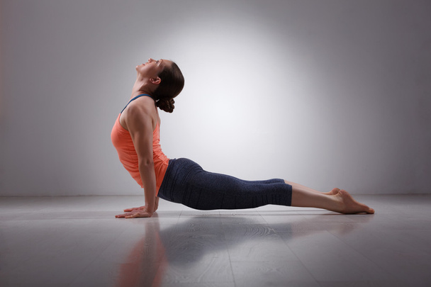 Sporty fit yogini woman practices yoga asana Urdhva mukha svanas - Photo, Image