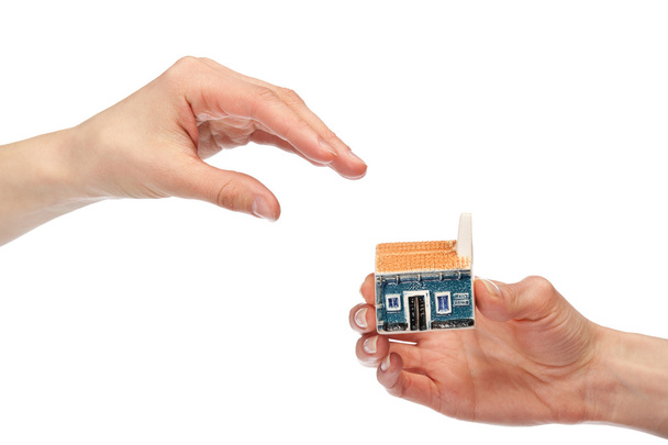 Hands giving and taking house model, - Foto, Imagen