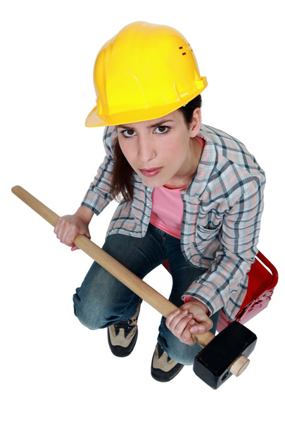 Female builder holding a sledge hammer - Foto, Imagen