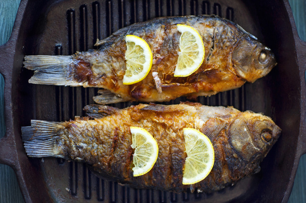 fried fish with fresh herbs and lemon - Photo, Image