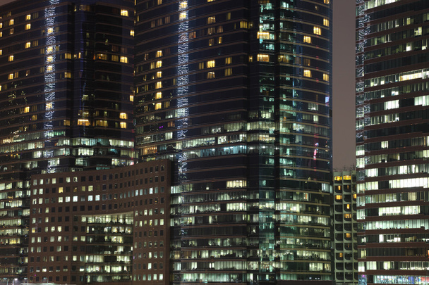 Highrise office buildgins illuminated at night - Valokuva, kuva