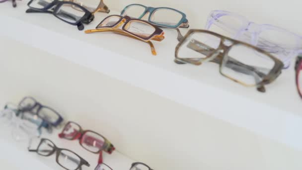 eyeglasses on the shelf in shop - Footage, Video