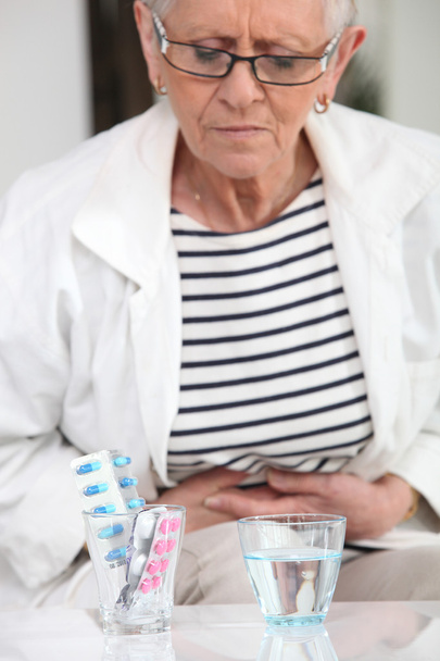 Woman about to take pain relievers - Fotoğraf, Görsel