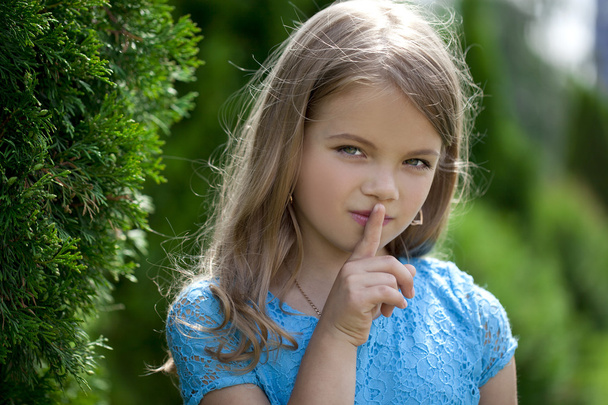 Little girl has put forefinger to lips as sign of silence - Zdjęcie, obraz