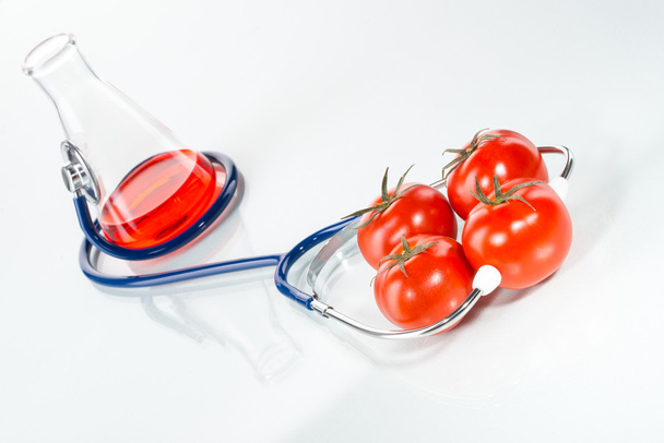 Stethoscope with tomatoes , analytical - 写真・画像