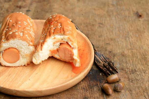 sausage bread on a wooden vintage - Фото, изображение