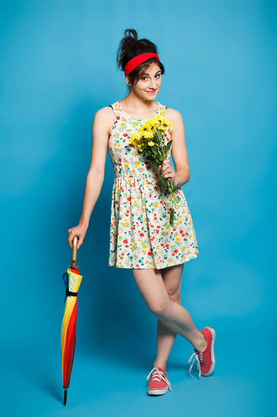 colorful portrait of young  funny  girl posing on blue wall  - Φωτογραφία, εικόνα