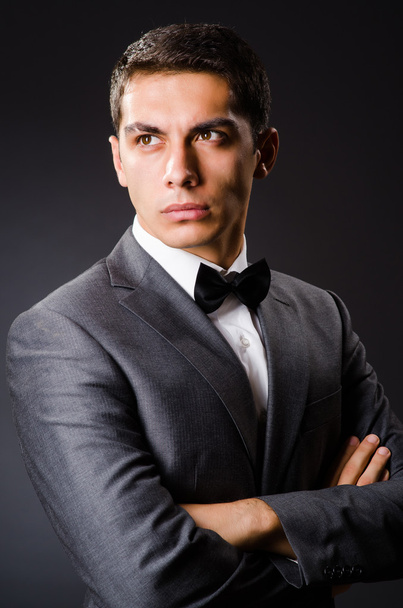 Young elegant man against gray - Photo, Image