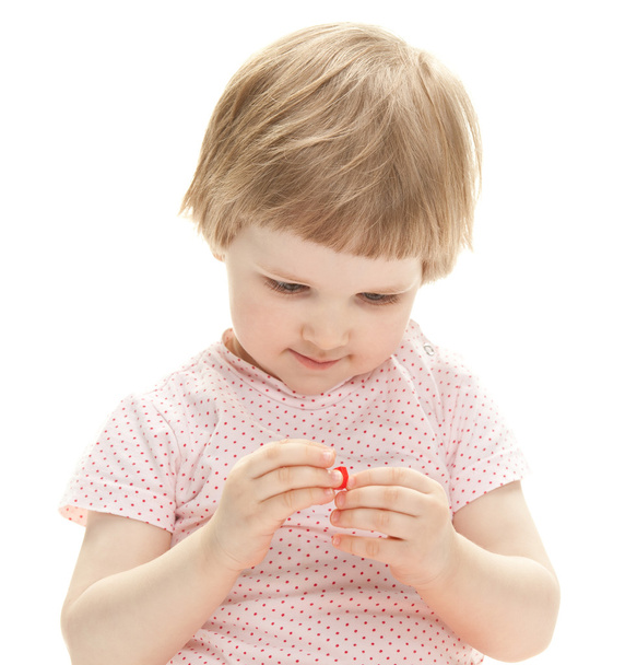 Girl examining small toy - Fotó, kép
