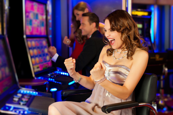 Friends in Casino on a slot machine - Photo, Image