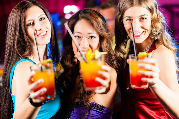 People with cocktails in bar or club - Фото, зображення