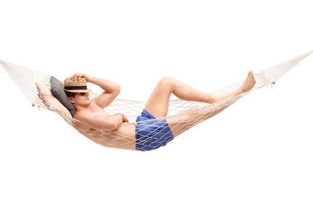 Shirtless young guy lying in a hammock - Photo, image