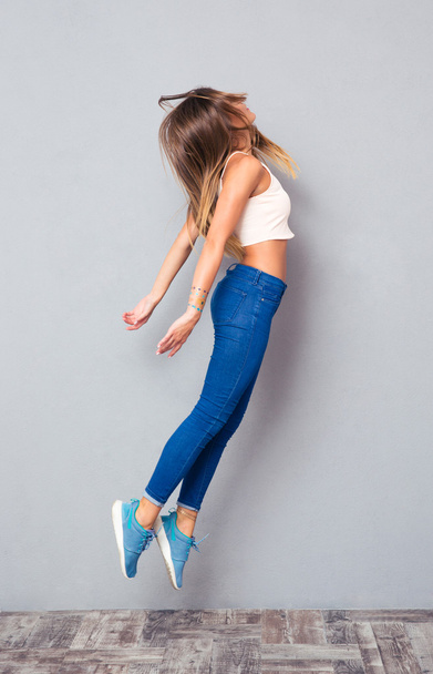 Full length portrait of a girl jumping - Zdjęcie, obraz