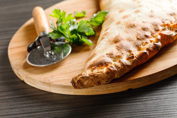 calzone pizza with knife - Photo, image