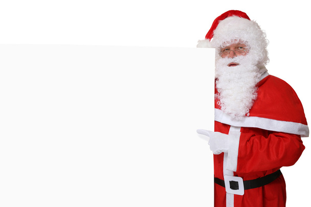 Santa Claus met hoed wijzend op Kerstmis op lege banner werkrug - Foto, afbeelding