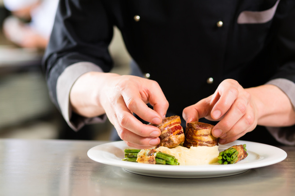 Chef in restaurant kitchen preparing food - Photo, Image