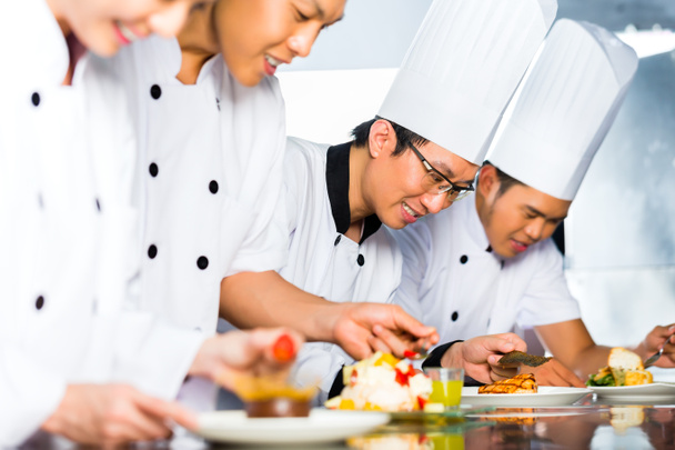 Asian Chefs in restaurant kitchen cooking - Photo, Image
