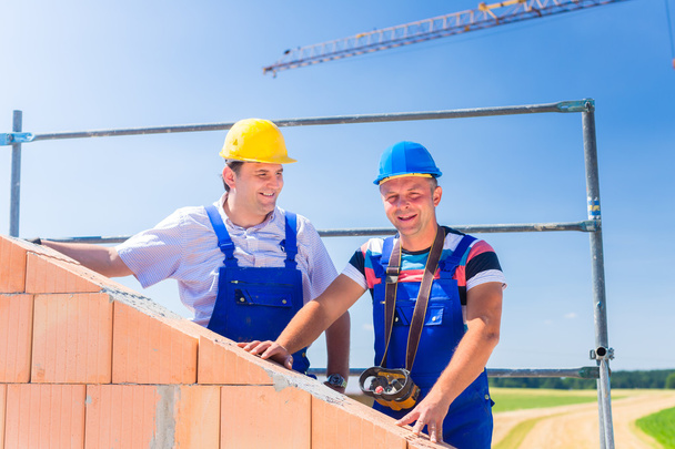 Construction site workers building house with crane - Fotoğraf, Görsel