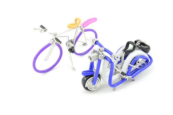 Wired purple miniature bicycle and blue scooter placed side by side isolated white background - Photo, Image