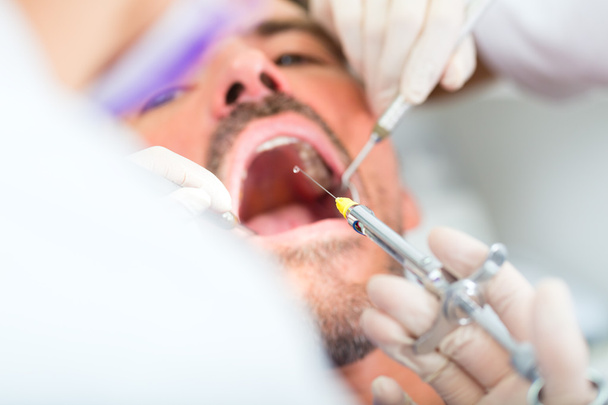 Zahnarzt gibt Behandlung - Betäubungsspritze  - Foto, Bild